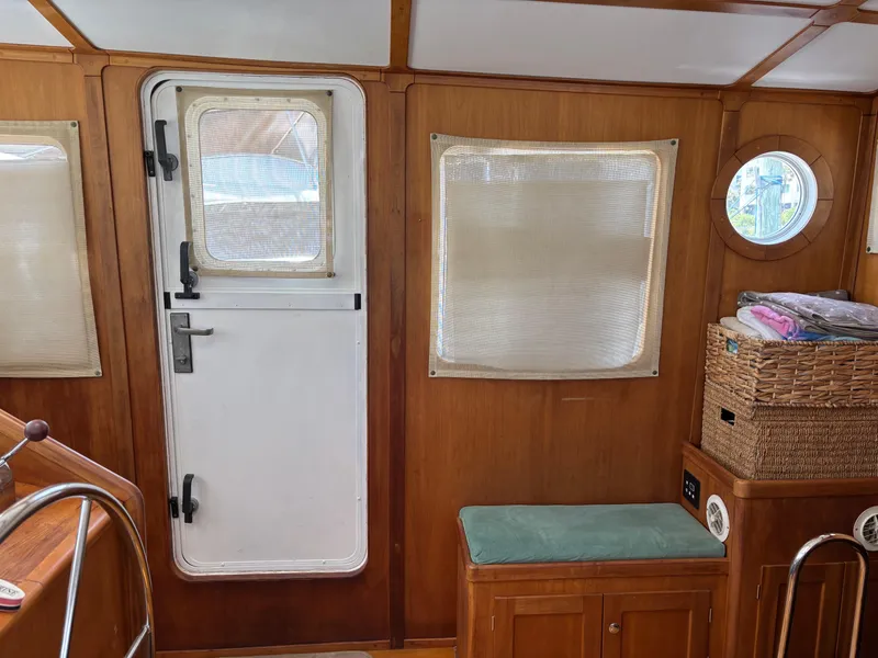 Slide: The Image of Interior of 1999 Diesel Duck Trawler with wooden paneling and nautical decor. - 2