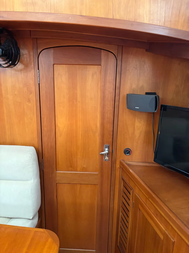 Slide: The Image of Wooden interior of a 1999 Diesel Duck Trawler with door, seating, and electronics. - 40