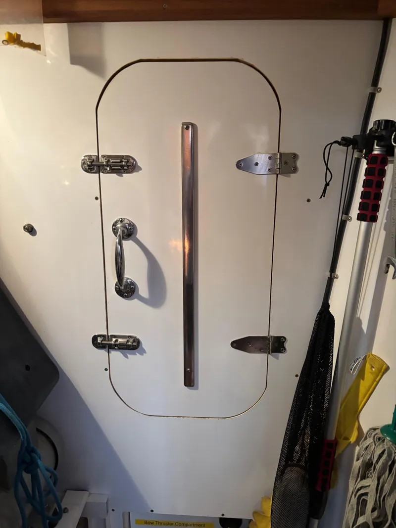 Slide: The Image of White door with metal handle on a 1999 Diesel Duck Trawler boat. - 42