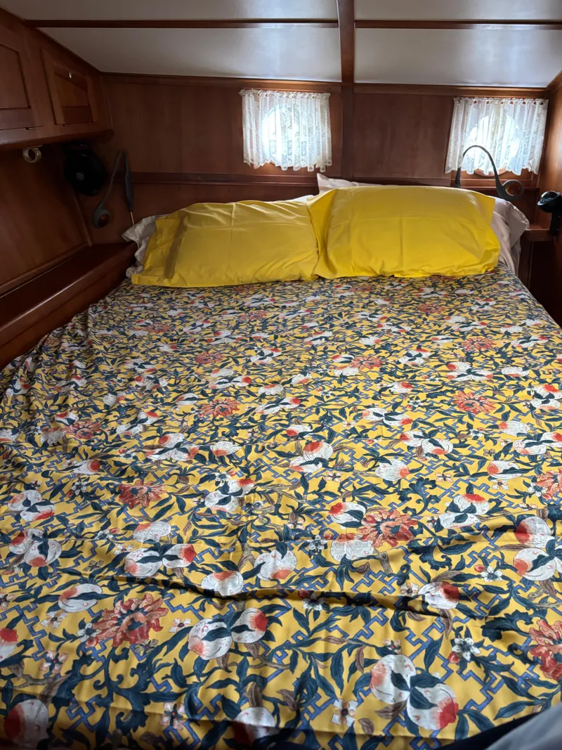 Slide: The Image of Cozy cabin bedroom in 1999 Diesel Duck Trawler with floral bedding and yellow pillows. - 46