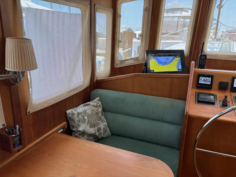 Slide: The Image of Interior of 1999 Diesel Duck Trawler with navigation equipment and cozy seating area. - 5
