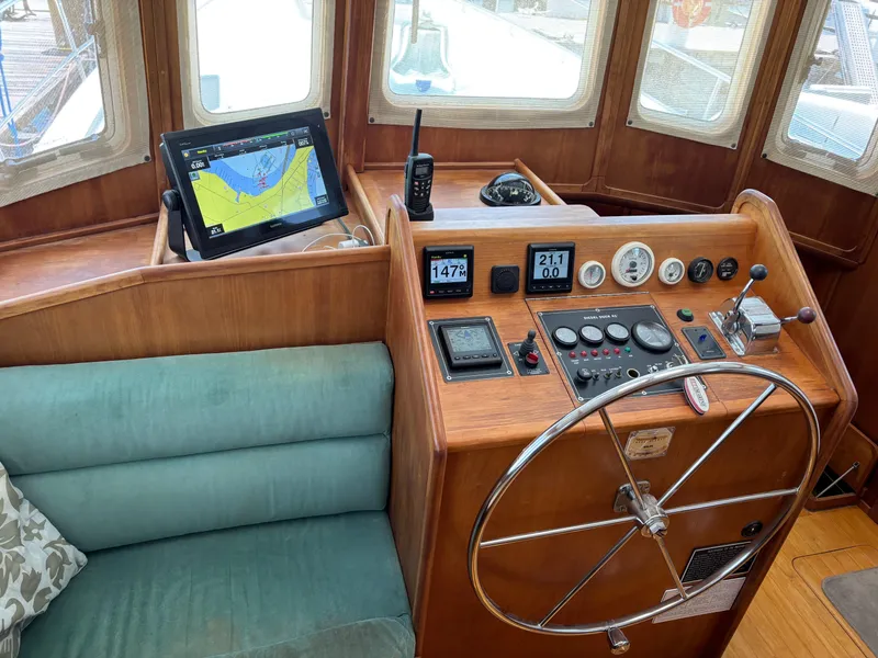 Slide: The Image of 1999 Diesel Duck Trawler helm with navigation equipment and steering wheel. - 8