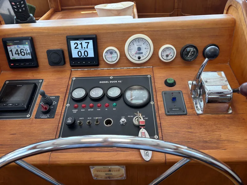 Slide: The Image of 1999 Diesel Duck Trawler dashboard with gauges, controls, and steering wheel. - 9
