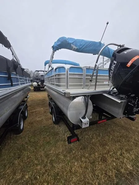 Slide: The Image of 2023 Trifecta 22RFC-CS275 Fish/Ski pontoon boat with Suzuki outboard motor, parked on grass. - 10