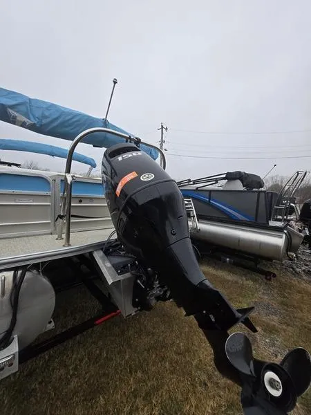 Slide: The Image of 2023 Trifecta 22RFC-CS275 FISH/SKI boat with powerful outboard motor, parked on grass. - 11