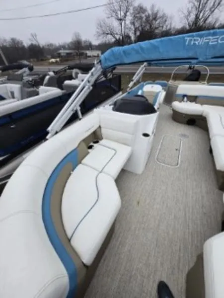 Slide: The Image of 2023 Trifecta 22RFC-CS275 Fish/Ski boat with spacious seating and blue accents. - 12