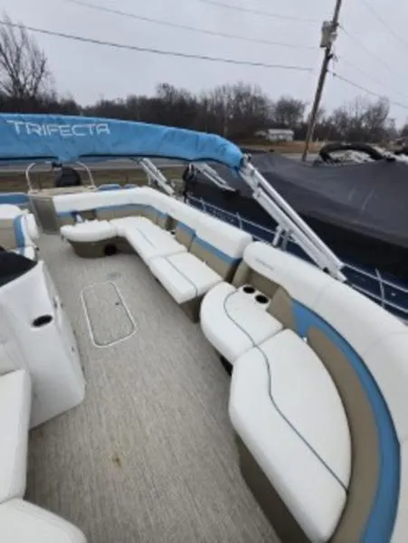 Slide: The Image of 2023 Trifecta 22RFC-CS275 FISH/SKI boat with spacious seating and blue canopy. - 8
