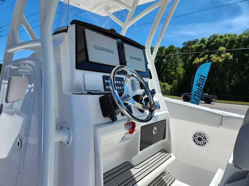Slide: The Image of 2023 Sea Fox 288 Commander boat dashboard with Garmin displays and steering wheel. - 2