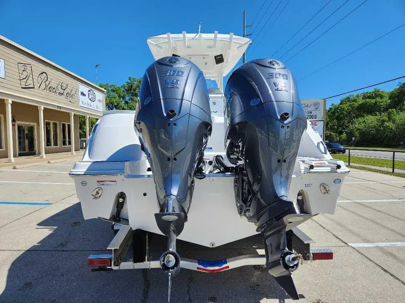 Slide: The Image of 2023 Sea Fox 288 Commander with dual outboard engines, parked outdoors. - 4