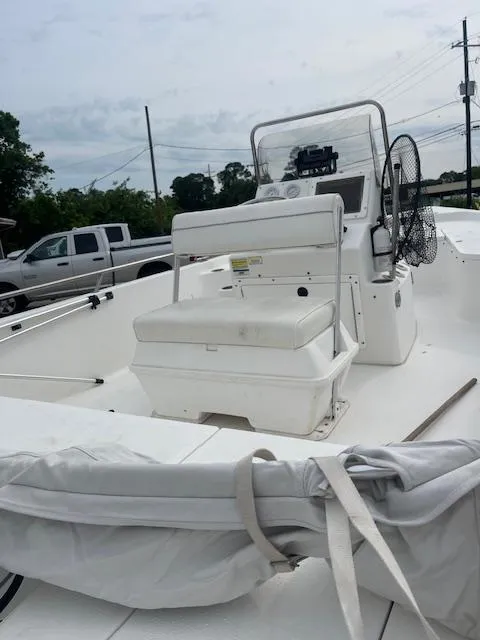 Slide: The Image of 2006 Seapro 2100 CC boat with center console and seating, parked outdoors. - 3