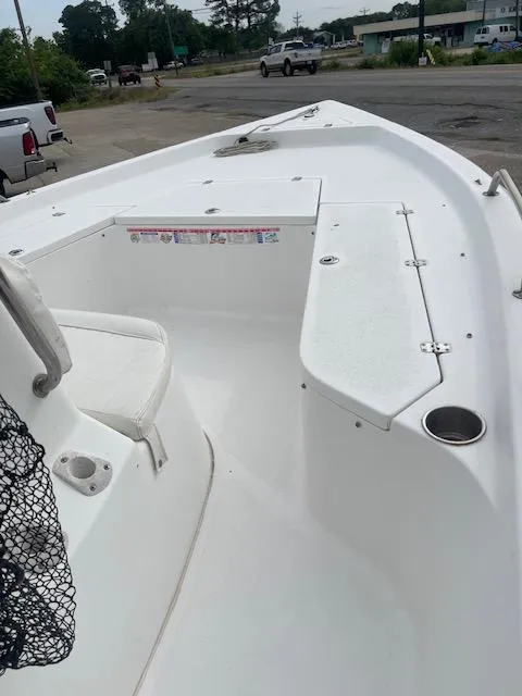 Slide: The Image of 2006 Seapro 2100 CC boat, white deck, spacious seating, cup holder, outdoor setting. - 5