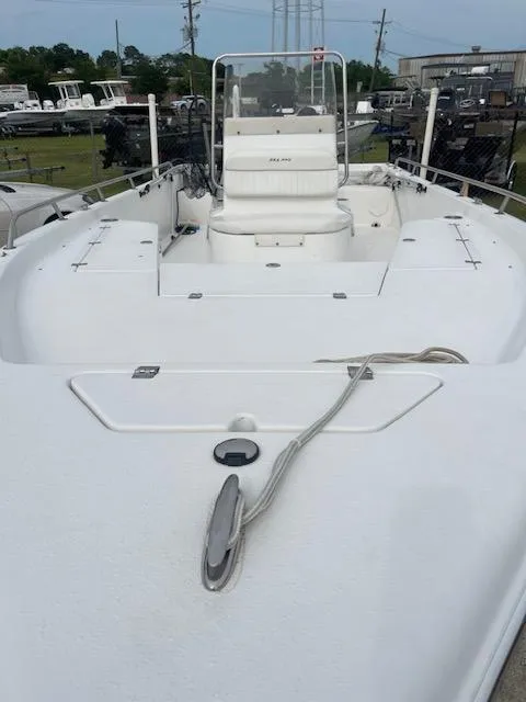 Slide: The Image of 2006 Seapro 2100 CC boat, white deck, center console, docked outdoors. - 6