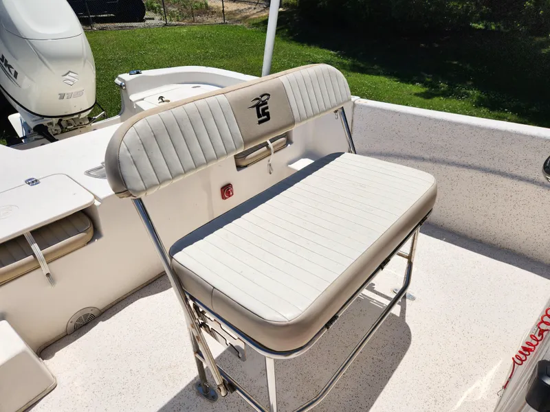 Slide: The Image of 2019 Carolina Skiff 198 DLV boat seat, white upholstery, stainless steel frame, outdoor setting. - 11