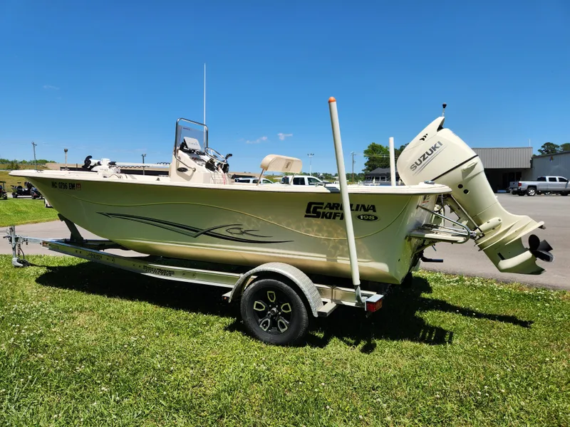 Slide: The Image of 2019 Carolina Skiff 198 DLV boat on trailer with Suzuki outboard motor. - 4