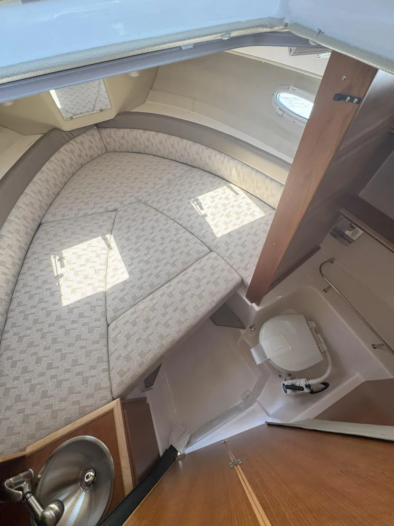Slide: The Image of 2025 Cutwater C-248 Coupe interior with cozy seating and compact bathroom. - 10