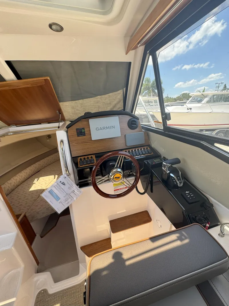 Slide: The Image of 2025 Cutwater C-248 Coupe interior with Garmin navigation, steering wheel, and seating. - 5