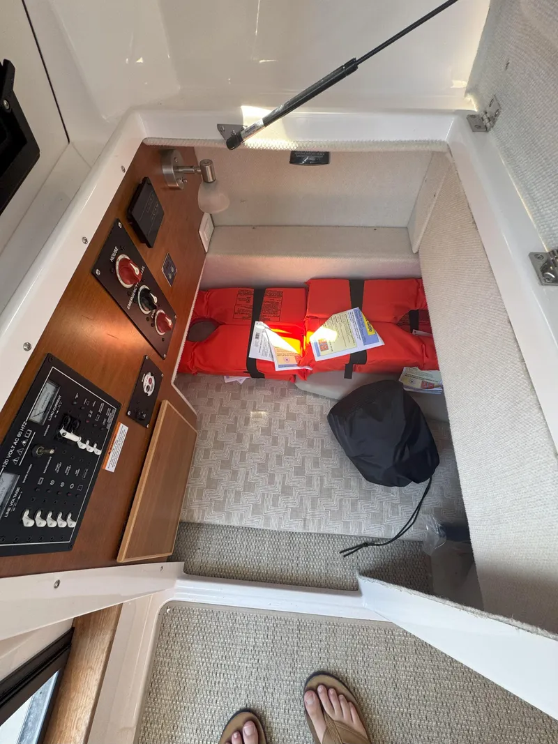 Slide: The Image of Interior view of 2025 Cutwater C-248 Coupe boat cabin with control panel and storage. - 6