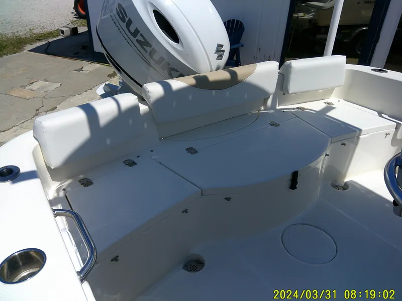 Slide: The Image of 2024 Bulls Bay 200 CC boat interior with Suzuki engine, featuring white seating and storage compartments. - 16