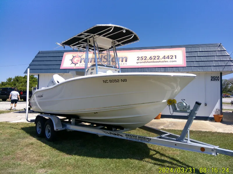 Slide: The Image of 2024 Bulls Bay 200 CC boat on trailer outside dealership under clear blue sky. - 2