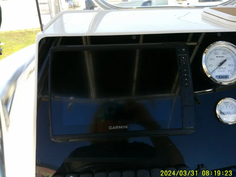 Slide: The Image of 2024 Bulls Bay 200 CC boat dashboard with Garmin display and gauges. - 20
