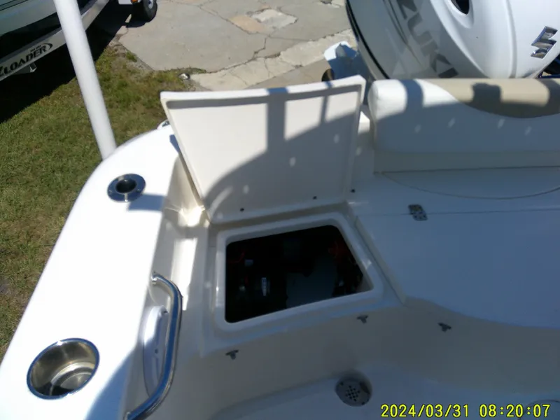 Slide: The Image of 2024 Bulls Bay 200 CC boat with open storage compartment and visible engine area. - 23