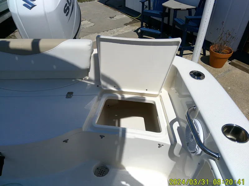 Slide: The Image of 2024 Bulls Bay 200 CC boat interior with open storage compartment and Suzuki engine. - 25