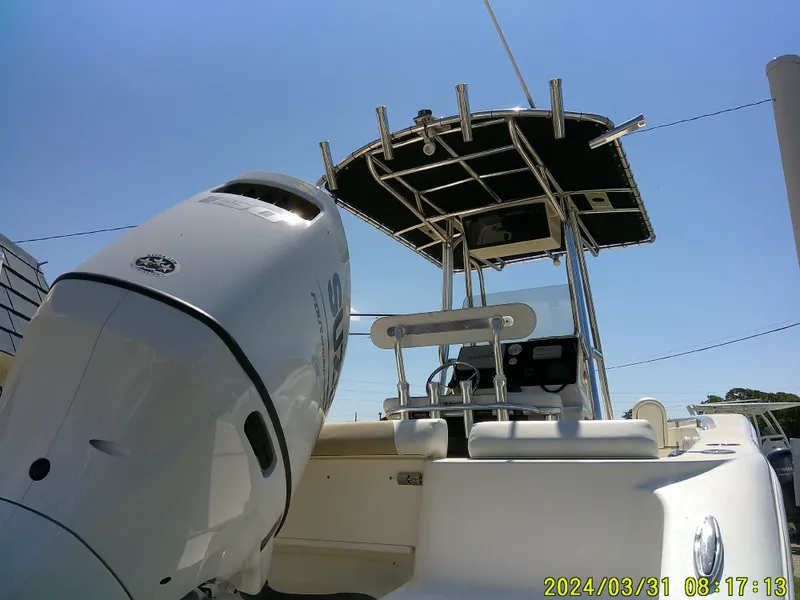 Slide: The Image of 2024 Bulls Bay 200 CC boat with outboard motor and T-top under clear blue sky. - 7