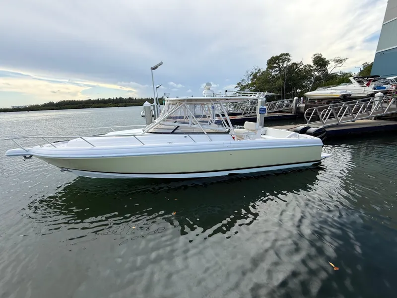 The Image of 2006 Intrepid 350 Center Console boat docked on calm water. - 0