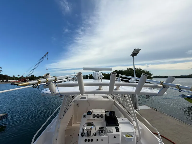 Slide: The Image of 2006 Intrepid 350 Center Console boat docked by a scenic waterfront. - 10