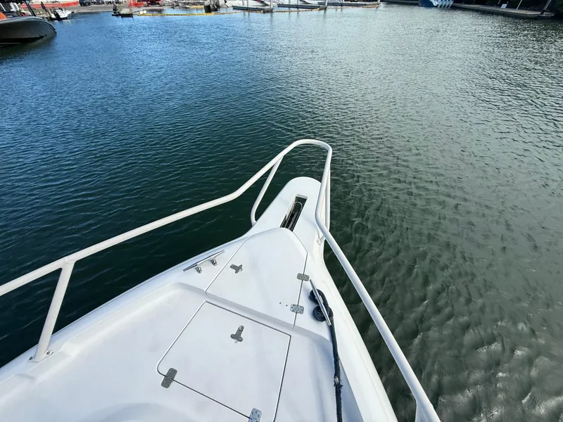 Slide: The Image of Bow view of a 2006 Intrepid 350 Center Console boat on calm water. - 12