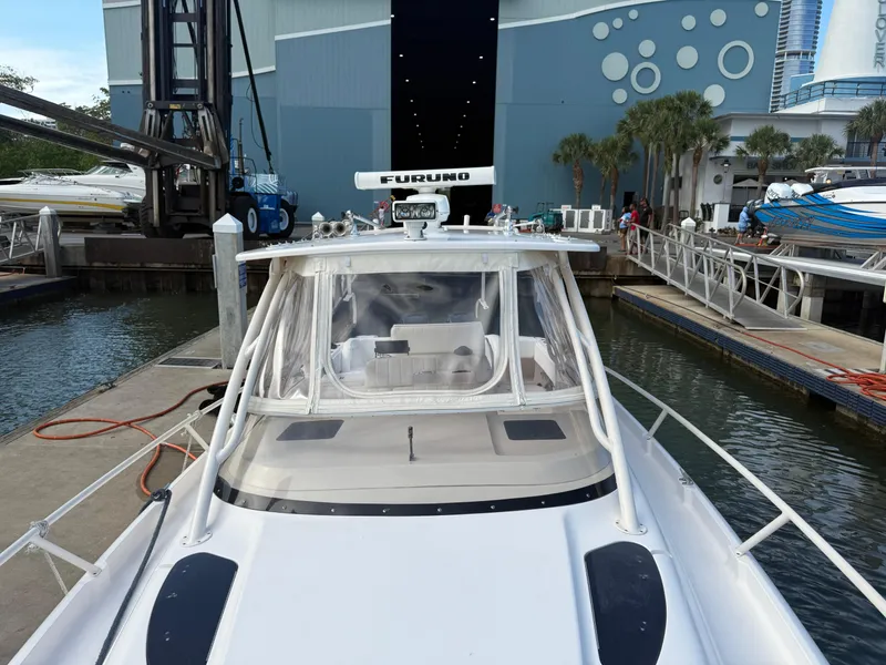 Slide: The Image of 2006 Intrepid 350 Center Console boat docked at marina with modern design. - 13
