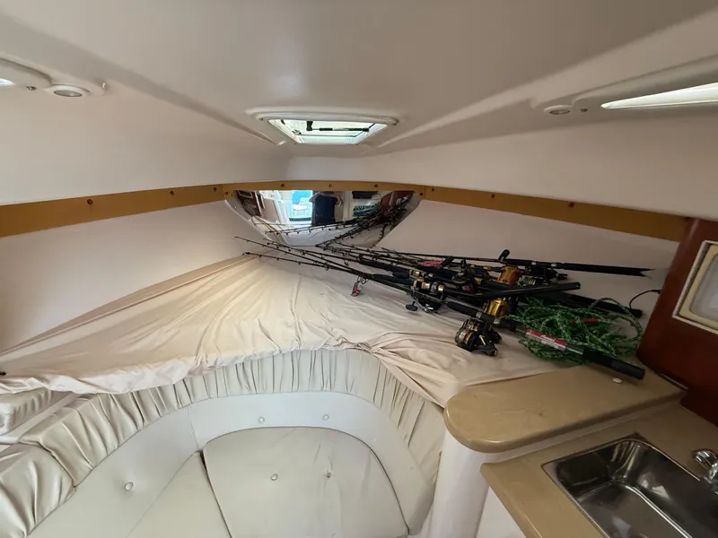 Slide: The Image of Interior cabin of a 2006 Intrepid 350 Center Console with fishing rods and a small sink. - 14