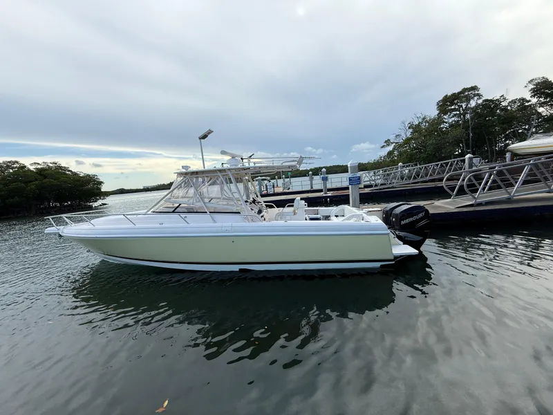 Slide: The Image of 2006 Intrepid 350 Center Console boat docked on calm water. - 19
