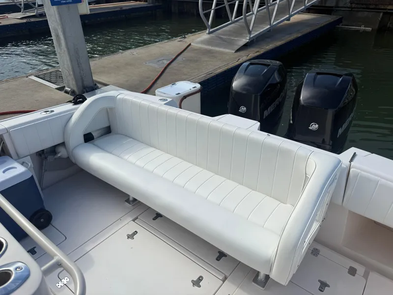Slide: The Image of 2006 Intrepid 350 Center Console boat with white seating and dual outboard motors. - 2