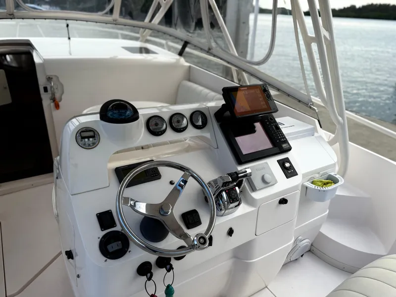 Slide: The Image of 2006 Intrepid 350 Center Console boat dashboard with steering wheel and navigation equipment. - 6