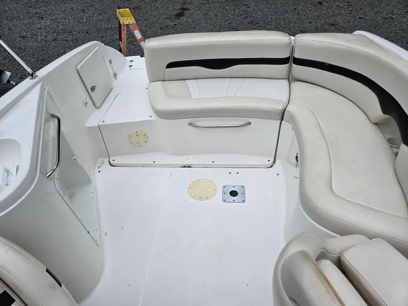 Slide: The Image of 2000 Chaparral 230 SSi boat interior with white seating and storage compartments. - 11