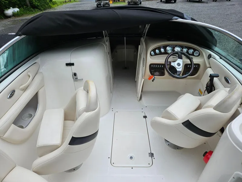 Slide: The Image of Interior of 2000 Chaparral 230 SSi boat with beige seating and dashboard. - 12
