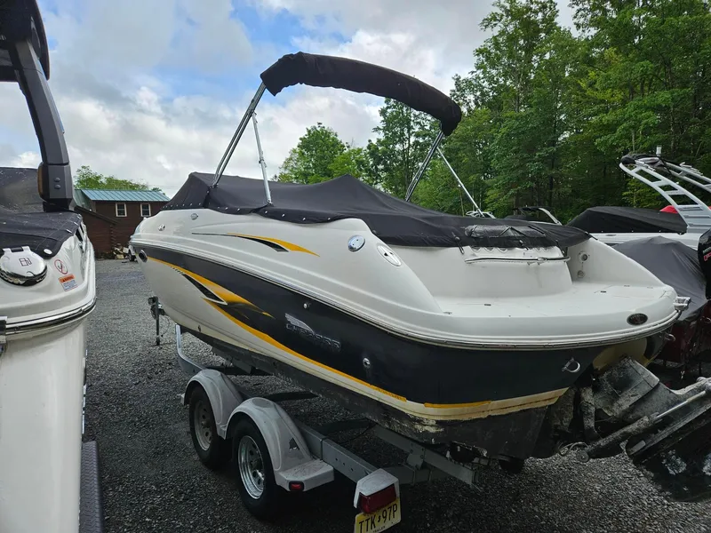 Slide: The Image of 2000 Chaparral 230 SSi boat on trailer, covered, parked outdoors. - 13