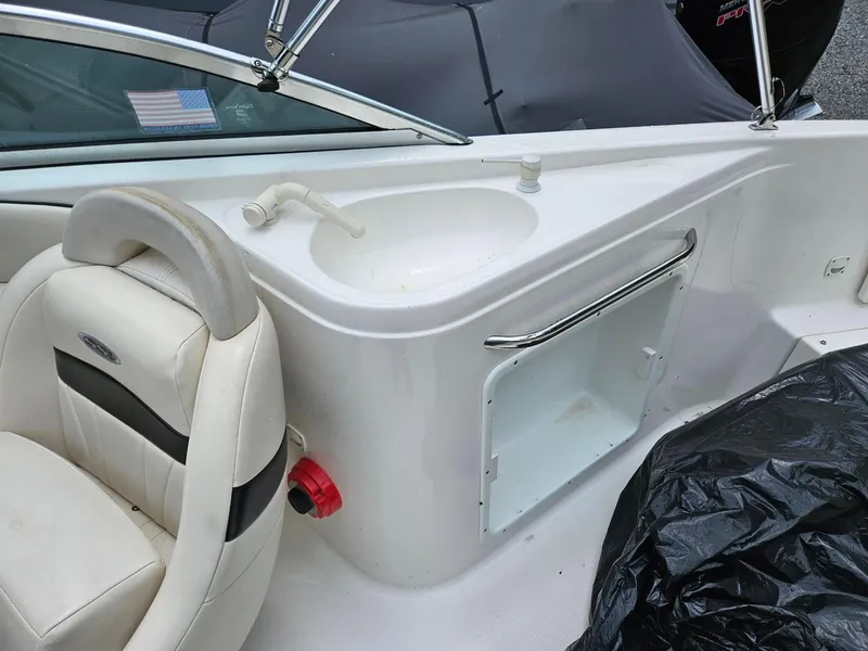 Slide: The Image of 2000 Chaparral 230 SSi boat interior with sink and seating area. - 14