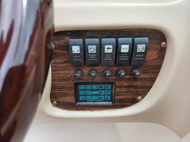 Slide: The Image of Control panel of a 2000 Chaparral 230 SSi boat with switches and buttons. - 15