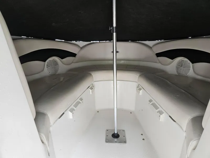 Slide: The Image of Interior of a 2000 Chaparral 230 SSi boat, featuring cushioned seating and speakers. - 17