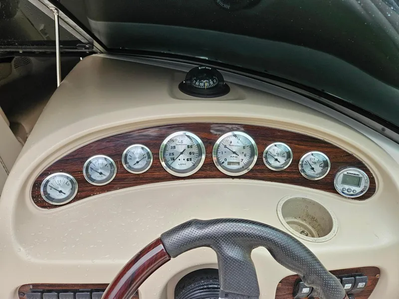 Slide: The Image of Dashboard of a 2000 Chaparral 230 SSi boat with gauges and steering wheel. - 19