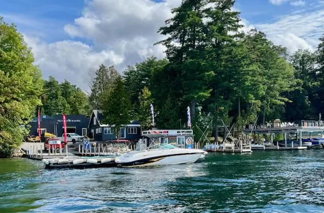 Slide: The Image of Chaparral 230 SSi boat docked at a scenic lakeside marina, surrounded by lush trees. - 2