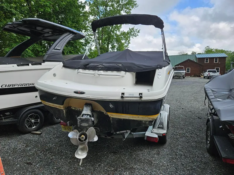 Slide: The Image of Chaparral 230 SSi 2000 boat with cover on trailer, parked outdoors. - 21