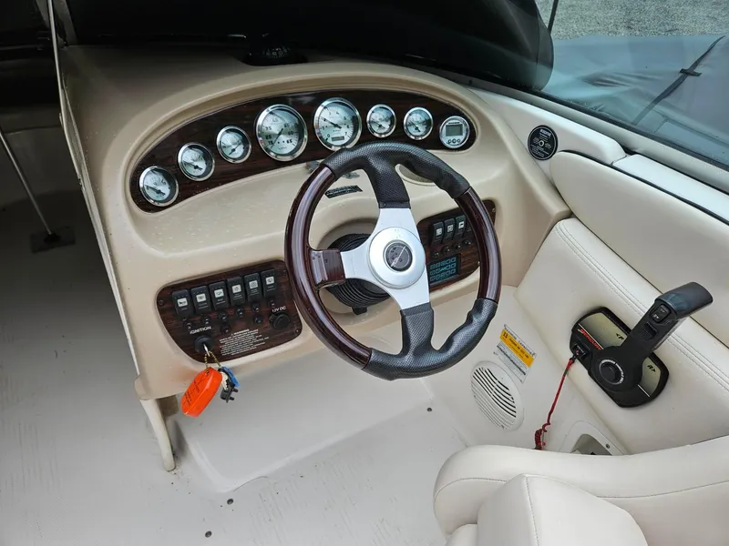 Slide: The Image of 2000 Chaparral 230 SSi boat dashboard with steering wheel and control panel. - 8