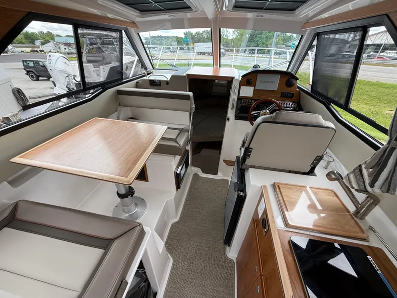 Slide: The Image of Interior of 2025 Cutwater C-248 Coupe boat with seating, table, and navigation equipment. - 10