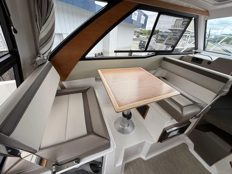 Slide: The Image of Interior of 2025 Cutwater C-248 Coupe, featuring a modern dining area with seating and table. - 11