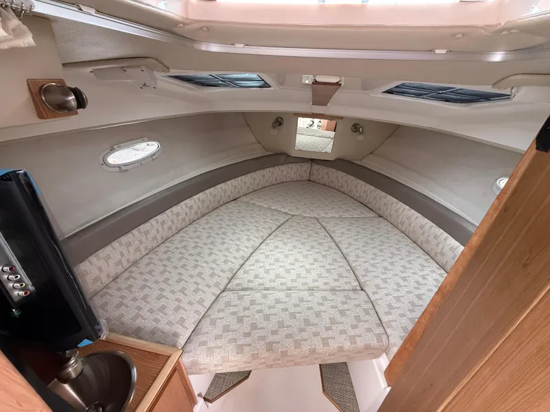 Slide: The Image of 2025 Cutwater C-248 Coupe cabin interior with cozy bed and modern design. - 15