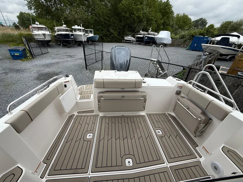 Slide: The Image of 2025 Cutwater C-248 Coupe boat deck with seating, in a marina setting. - 6