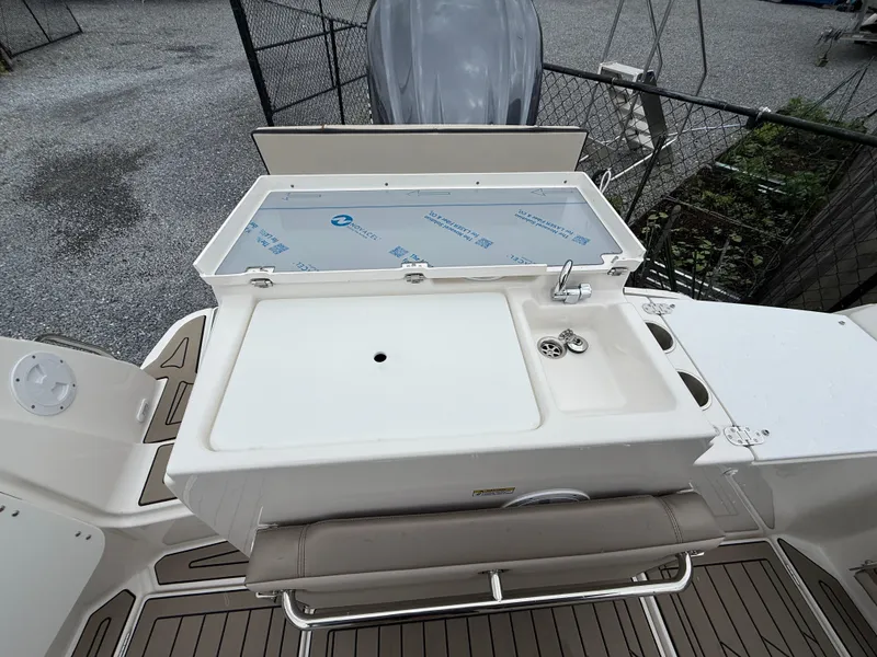 Slide: The Image of 2025 Cutwater C-248 Coupe boat deck with sink and storage area. - 8